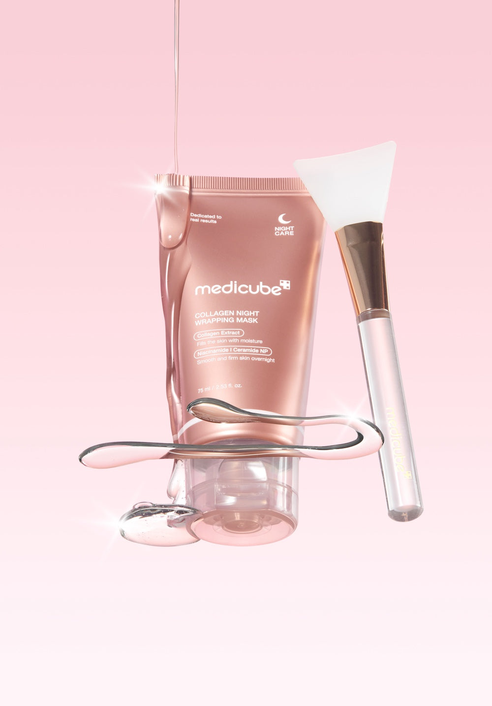 Medicube skincare product with a brush on a pink background