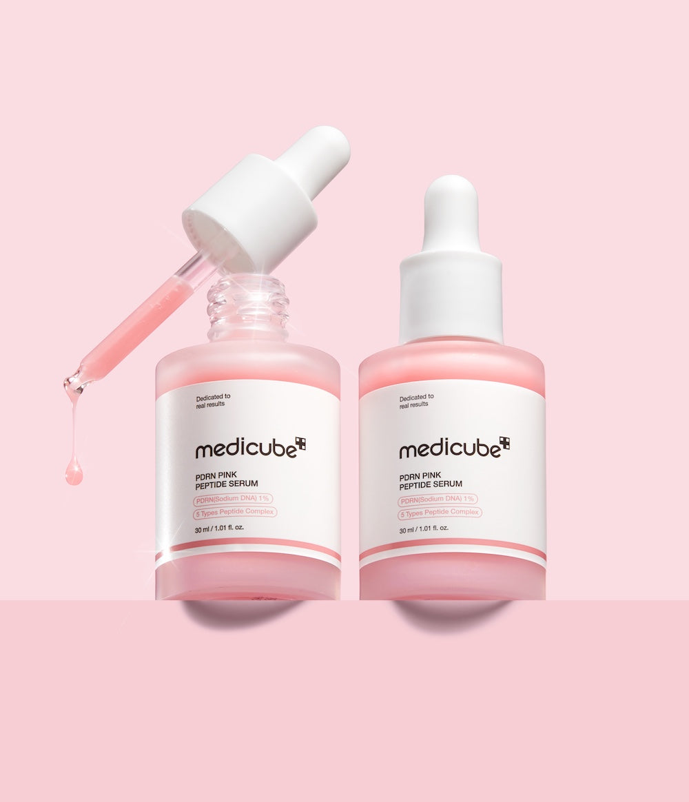 Two bottles of Medicube Pore Pink Peptide Serum on a pink background